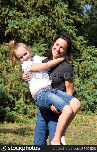 Photo of smiling playing mother and daughter