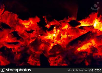 Photo of smouldering coal in dark night