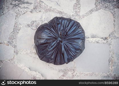 Photo of Sorted Garbage in the Plastic Biodegradable Bag. Black Trash Bag onthe Floor. Recycle to Save the Planet from Waste and Pollution. Black Garbage Bag