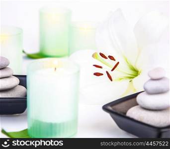 Photo of spa still life, white lily flower, candles, pebble stones, alternative treatment, enjoying dayspa, aroma therapy, aromatic massage, body care, essential oil, luxury spa salon, harmony concept