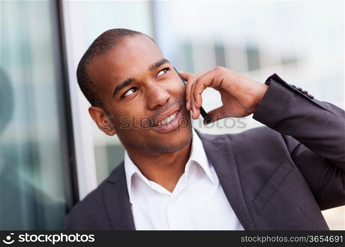 photo of successful african businessman phoning while smiling