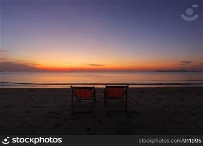 photo of sunbed on the beach with beautiful sky background