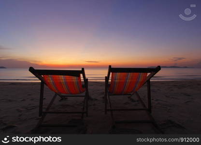 photo of sunbed on the beach with beautiful sky background