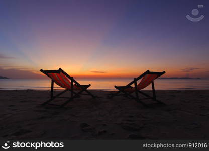 photo of sunbed on the beach with beautiful sky background