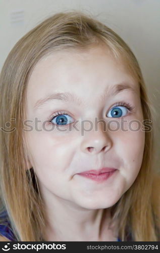 Photo of surprised cute girl with blond hair