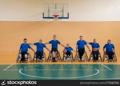  photo of the basketball team of war invalids with professional sports equipment for people with disabilities on the basketball court. High quality photo. photo of the basketball team of war invalids with professional sports equipment for people with disabilities on the basketball court