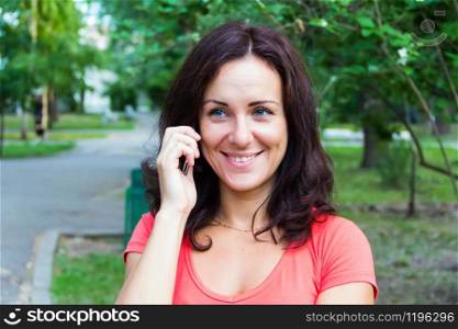 Photo of the brunette talking by cellular