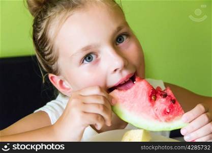 Photo of the cute girl eating watermelon and melon