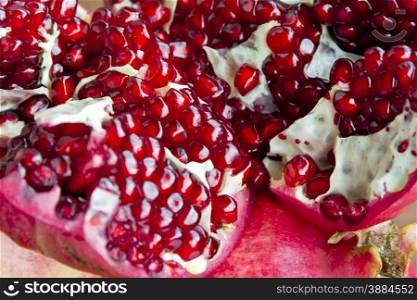 Photo of the dark red pomegranate is cut open