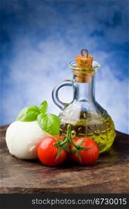 photo of tomato mozzarella on wooden table in front of blue background