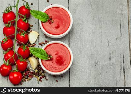 Photo of tomato soup over wooden table