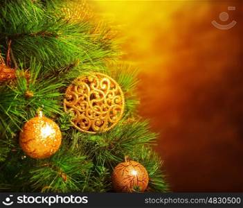 Photo of traditional Christmas tree isolated on brown grunge background, green fir decorated with golden bubbles toy, happy New Year greeting card, adorned pine tree at home, winter holidays