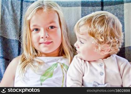 Photo of two cute blond girls with blue eyes