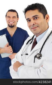 Photo of two doctors standing together smiling. Focus is on doctor on right.