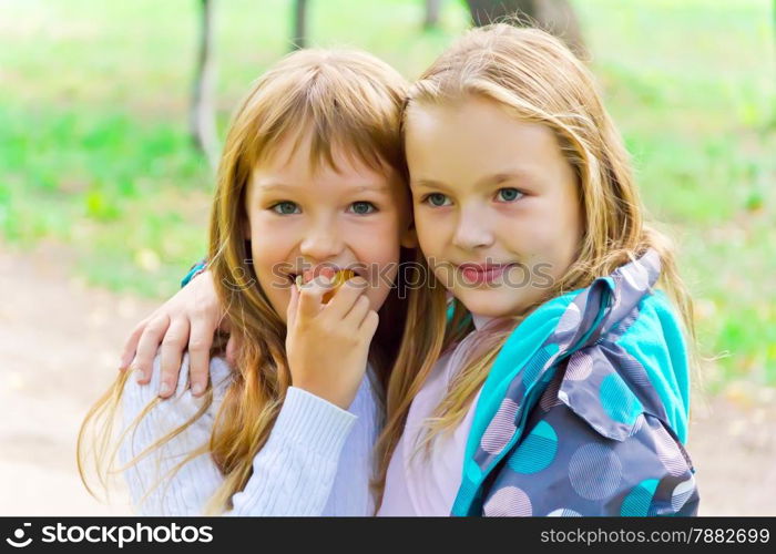 Photo of two eating girls in summer