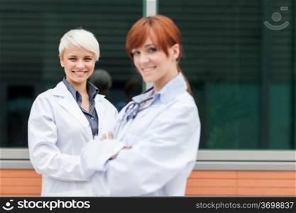 photo of two female doctors smiling towards the camera