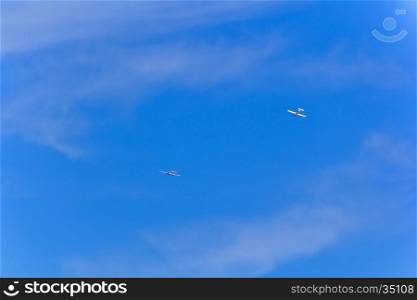 Photo of two flying military airplanes in blue sky. Two military airplanes