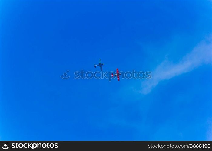 Photo of two flying planes in blue sky