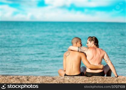 photo of two men in love hugging each other in front of the sea