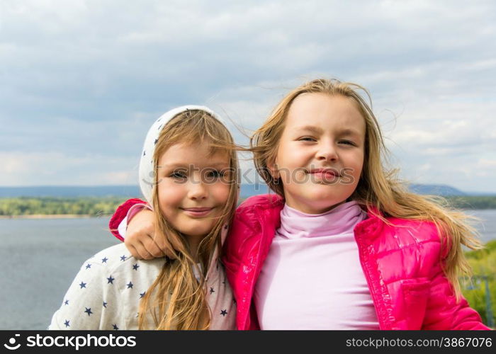 Photo of two playing girls in summer