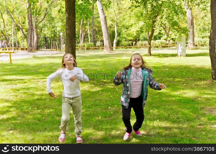 Photo of two running girls in summer