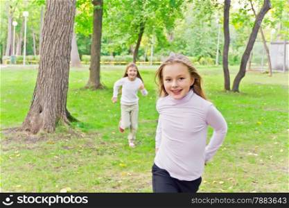 Photo of two running girls in summer