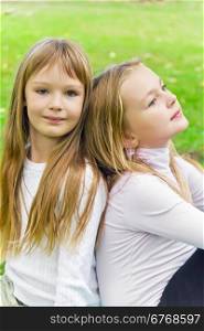 Photo of two sitting girls in summer