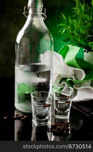 photo of two small glass with sambuca inside and coffee beans