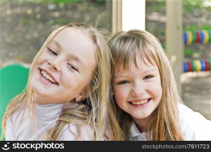 Photo of two smiling girls in summer