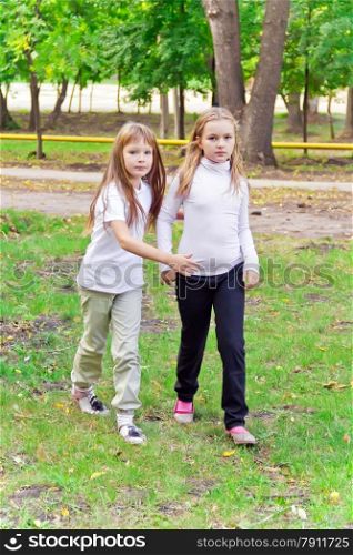 Photo of two walking girls in summer