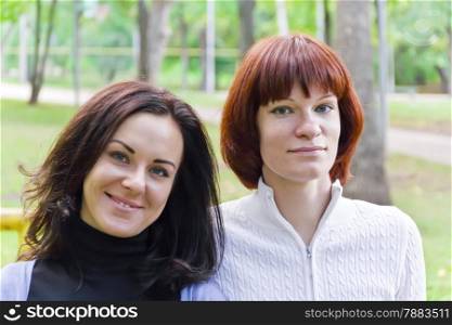 Photo of two women with brown and black hairs
