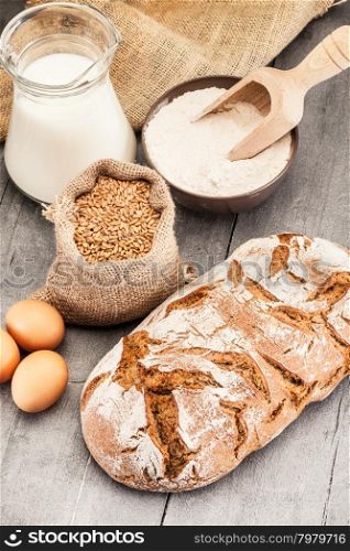 Photo of wheat bread over wooden table