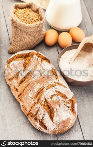 Photo of wheat bread over wooden table