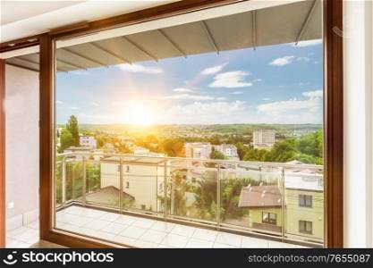 Photo of window view inside apartment with lens flare in background