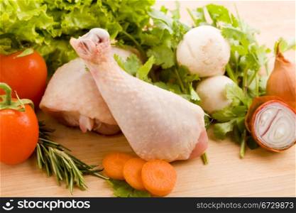 photo of wooden chopping board with chicken and vegetables