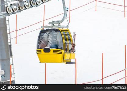 Photo of yellow cable car on Alpine ski slope