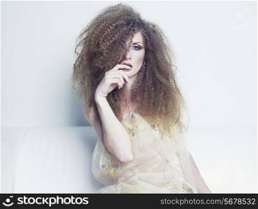 Photo of young beautiful woman with magnificent curly hair