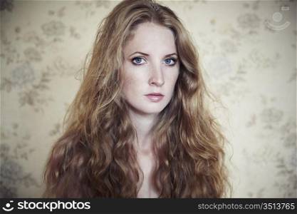 Photo of young beautiful woman with red curly hair