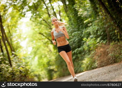 Photo of young blonde woman doing running activities