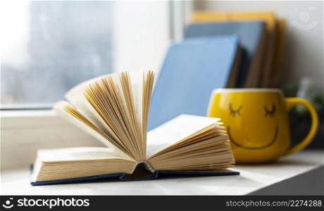 Photo Open book and smiley cup. Resolution and high quality beautiful photo. Photo Open book and smiley cup. High quality beautiful photo concept