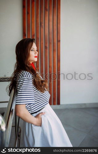 Photo shoot of an adult girl in a pioneer tie.. A perky girl in a striped T-shirt with a red tie 4165.