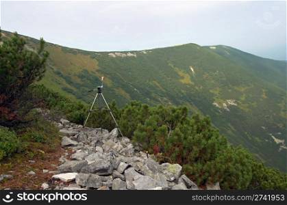 Photo tripod on mountain stony path