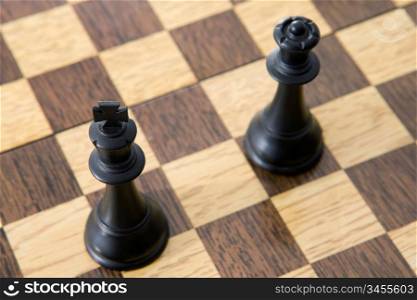 Photo view from above of chess pieces on the board: The king and the queen