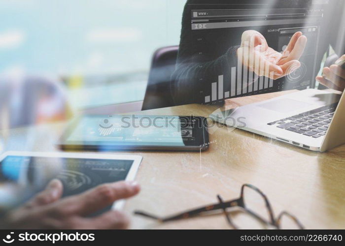 Photo website graphic designer hand meeting team with new project modern studio.Modern laptop digital tablet smart phone on marble table.Books papers documents, sun flare effect 