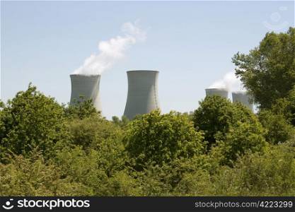 photograph of chimneys of a nuclear power plant in activity