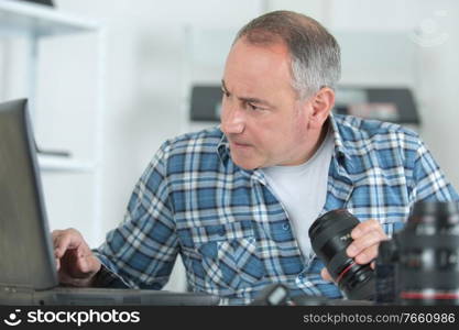 photographer checking photos in laptop