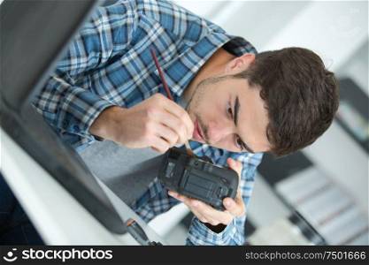 photographer cleaning photocamera light sensor