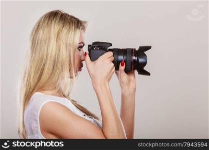 Photographer girl shooting images. Attractive blonde woman face profile taking photo with camera.