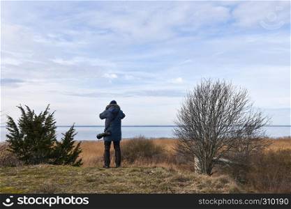 Photographer in a coastal landscape at the swedish island Oland