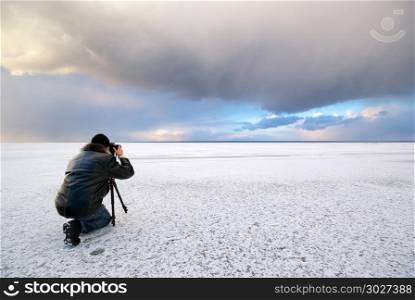 Photographer in work at winter on ice.. Photographer in work